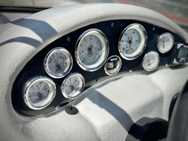Slide: The Image of Dashboard of a 2011 Tahoe Q8 SSi boat with multiple gauges and controls. - 25