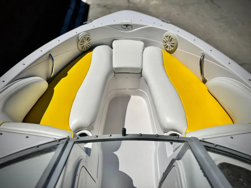 Slide: The Image of 2011 Tahoe Q8 SSi boat interior with yellow and white seating, featuring speakers and handles. - 9