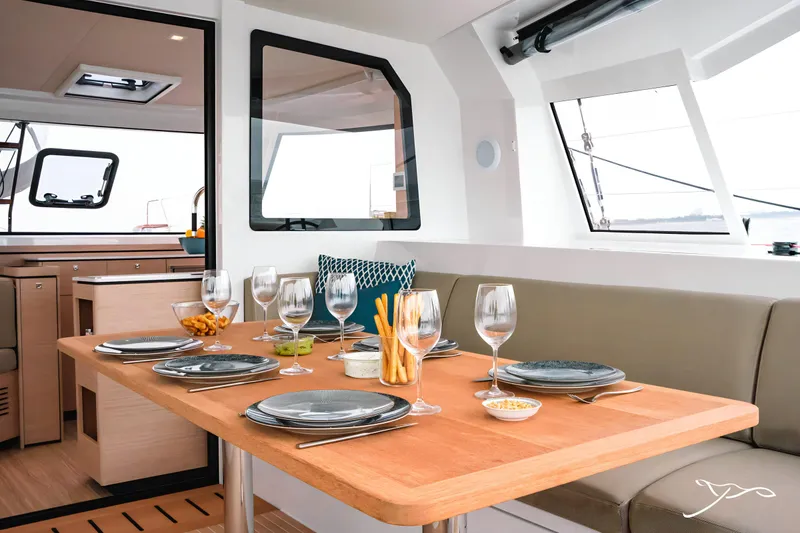 Slide: The Image of Luxurious dining area on 2025 Nautitech 40 Open catamaran, featuring elegant table setting and modern interior. - 23
