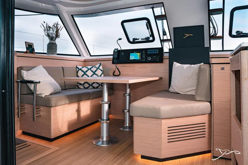 Slide: The Image of Interior of 2025 Nautitech 40 Open catamaran, featuring modern seating and navigation equipment. - 30