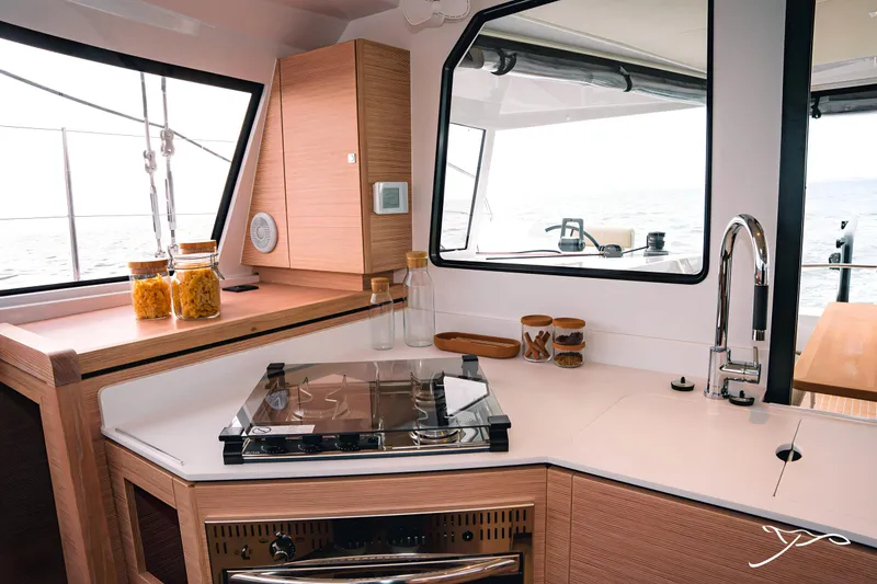 Slide: The Image of Modern kitchen interior of 2025 Nautitech 40 Open catamaran with sleek design and ocean view. - 36