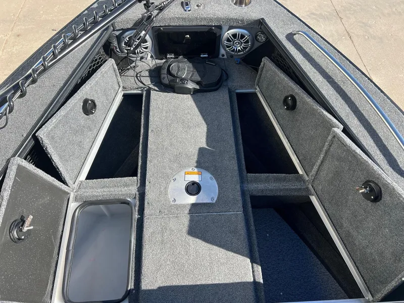 Slide: The Image of 2019 Alumacraft Trophy 175 boat interior with storage compartments and speaker system. - 14