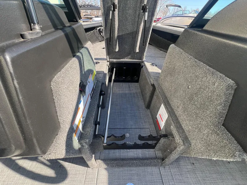 Slide: The Image of 2019 Alumacraft Trophy 175 boat interior storage compartment with carpeted finish. - 16
