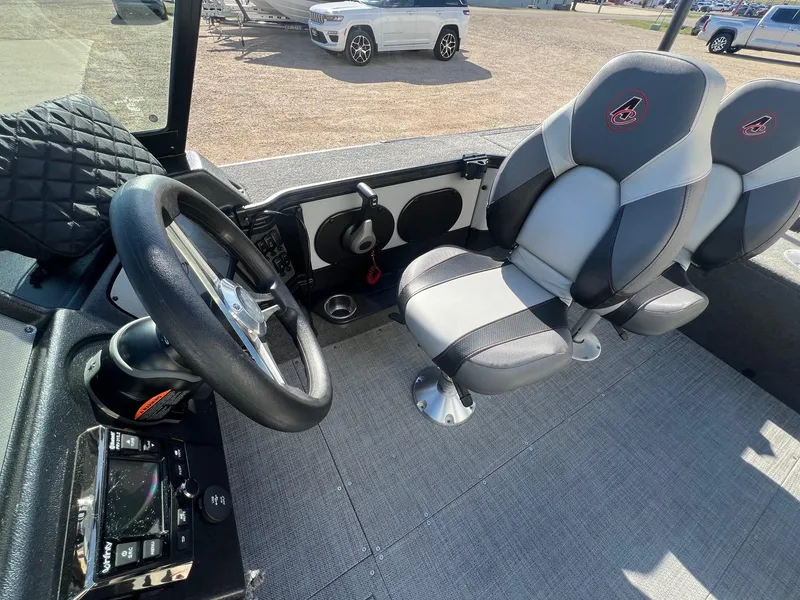 Slide: The Image of 2019 Alumacraft Trophy 175 boat interior with steering wheel and seating. - 18