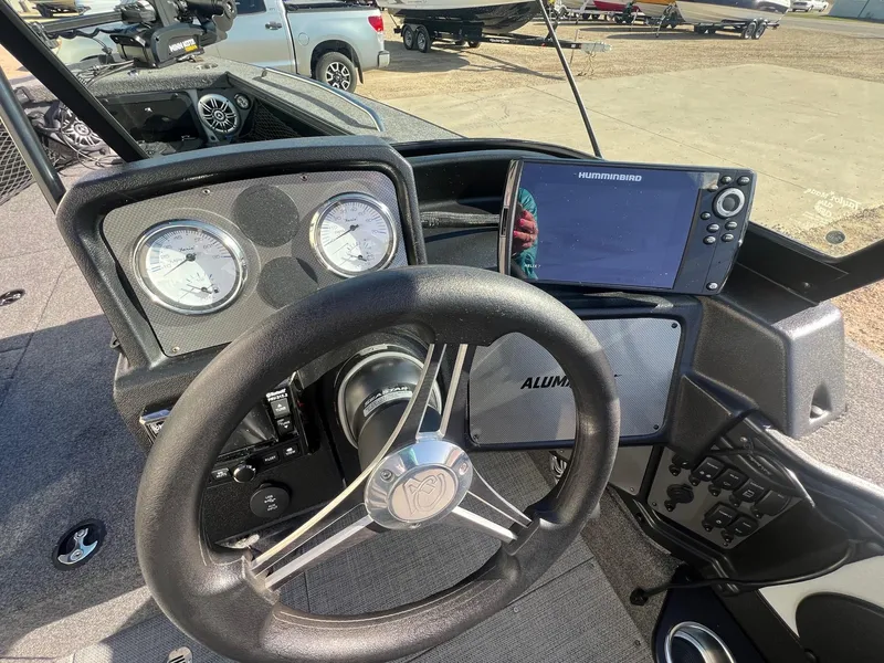 Slide: The Image of 2019 Alumacraft Trophy 175 dashboard with steering wheel and Humminbird fish finder. - 19