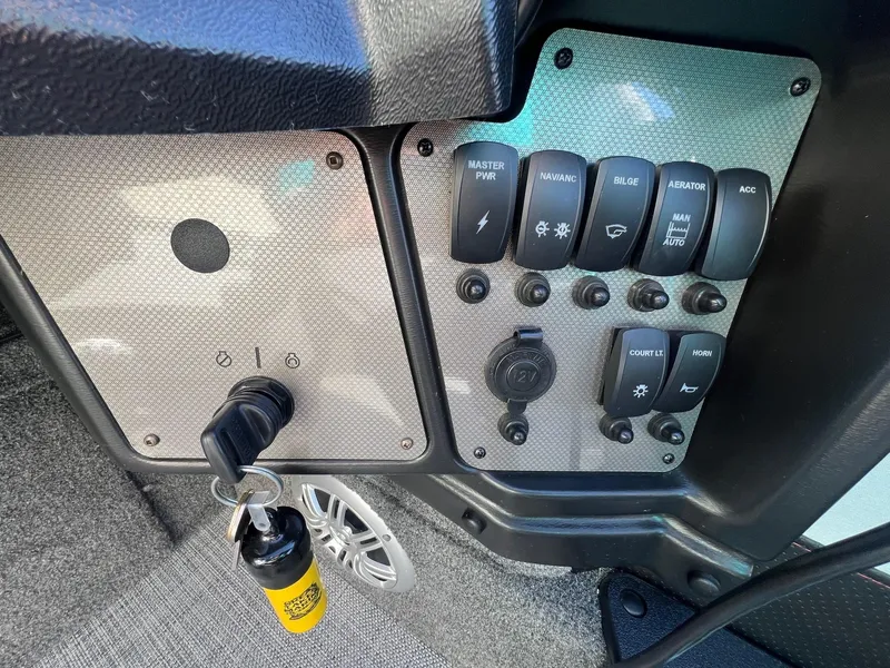 Slide: The Image of Control panel of a 2019 Alumacraft Trophy 175 boat with switches and ignition key. - 22