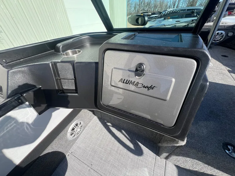 Slide: The Image of 2019 Alumacraft Trophy 175 boat interior with storage compartment and cup holder. - 24