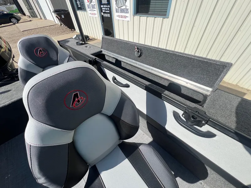 Slide: The Image of 2019 Alumacraft Trophy 175 boat interior with gray seats and storage compartment. - 26