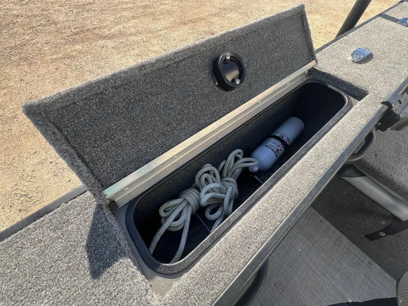 Slide: The Image of 2019 Alumacraft Trophy 175 storage compartment with rope and fire extinguisher. - 27