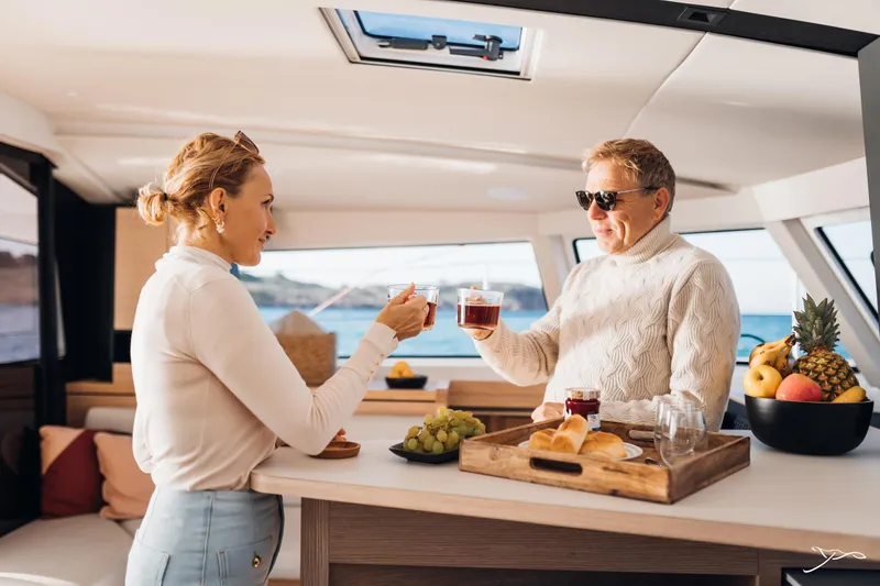Slide: The Image of Couple enjoying drinks on a 2025 Nautitech 44 Open yacht, with fruit and snacks. - 39
