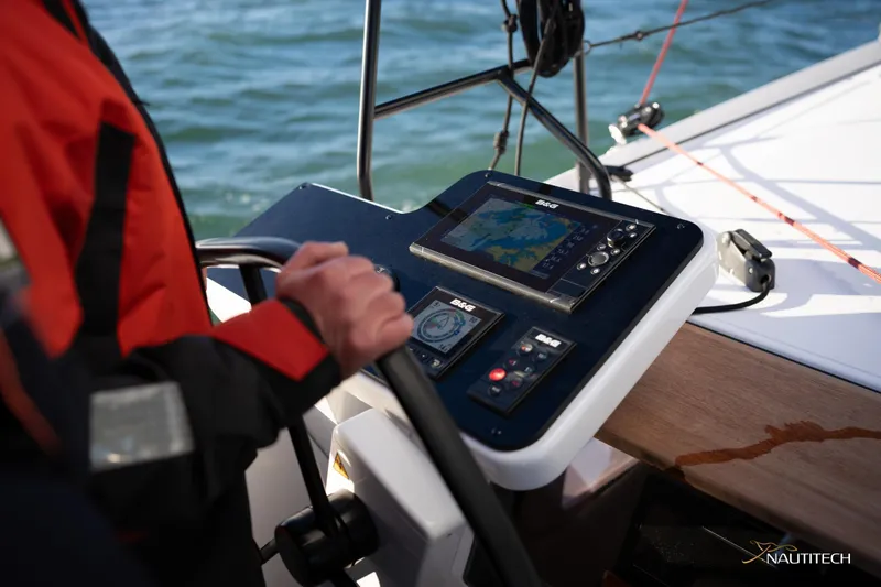 Slide: The Image of Person steering Nautitech 48 Open yacht, 2025 model, with navigation controls visible. - 13