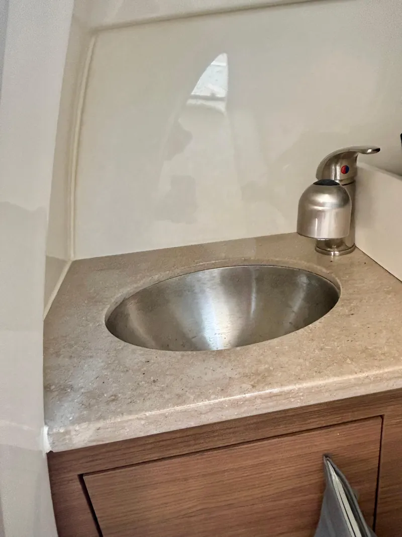 Slide: The Image of 2020 Boston Whaler 280 Vantage boat sink with stainless steel basin and modern faucet. - 12
