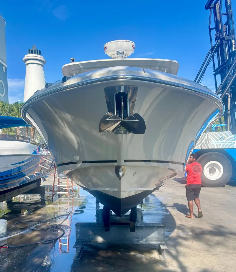 Slide: The Image of 2020 Boston Whaler 280 Vantage boat on dock, lighthouse in background, sunny day. - 14