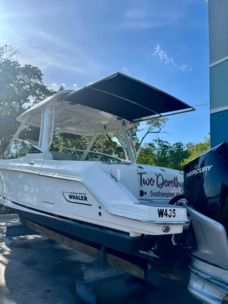 Slide: The Image of 2020 Boston Whaler 280 Vantage boat on trailer, featuring Mercury engine, sunny day. - 15