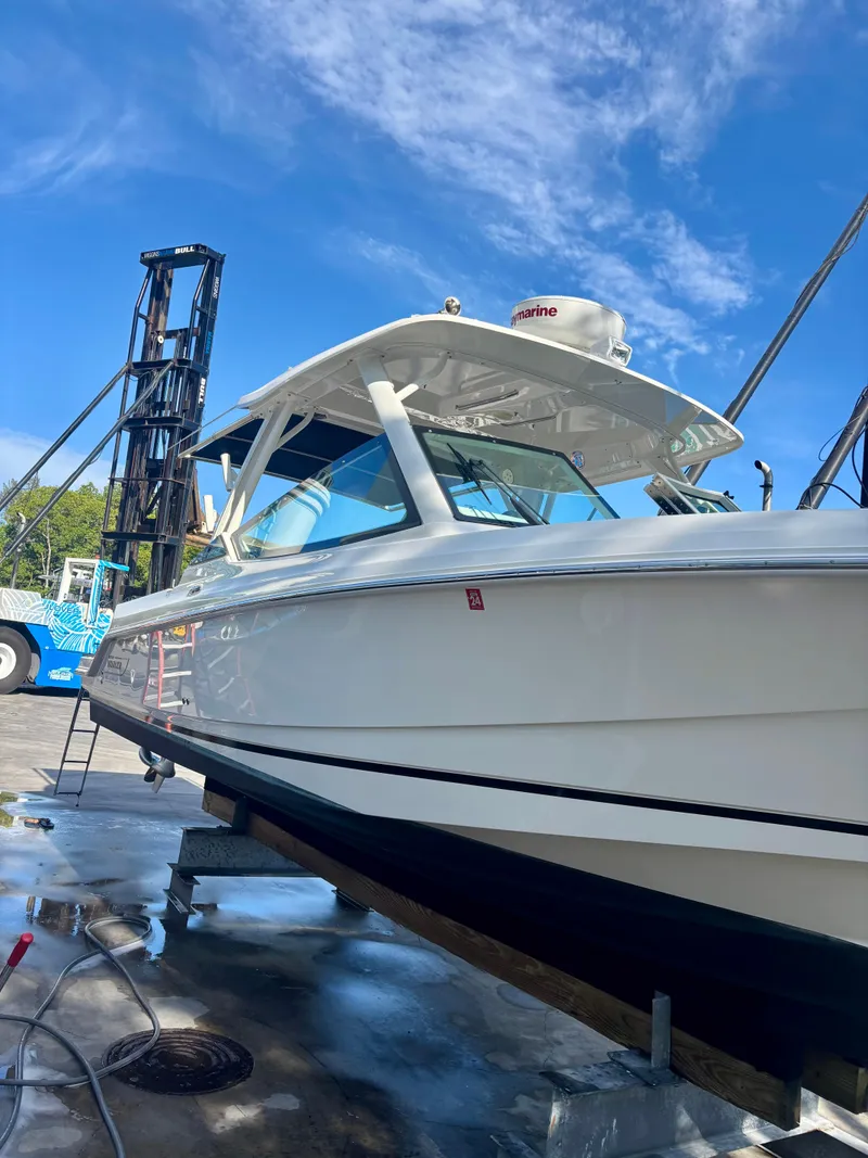 Slide: The Image of 2020 Boston Whaler 280 Vantage boat on dock under clear blue sky. - 16