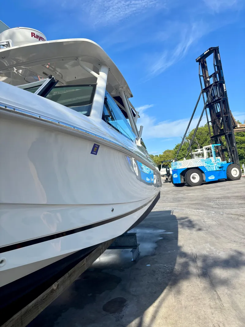 Slide: The Image of 2020 Boston Whaler 280 Vantage boat on dock with forklift in background. - 17