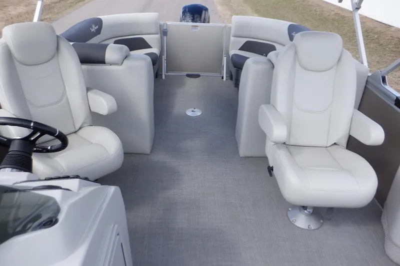 Slide: The Image of 2024 SunChaser Geneva Cruise 22 LR DH boat interior with steering wheel and seating. - 19
