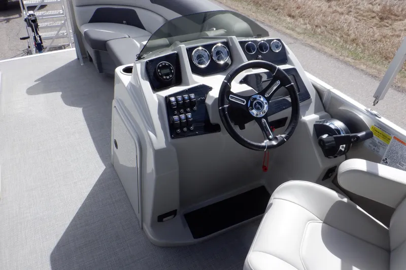Slide: The Image of 2024 SunChaser Geneva Cruise 22 LR DH boat interior with gray and black cushioned seating. - 26