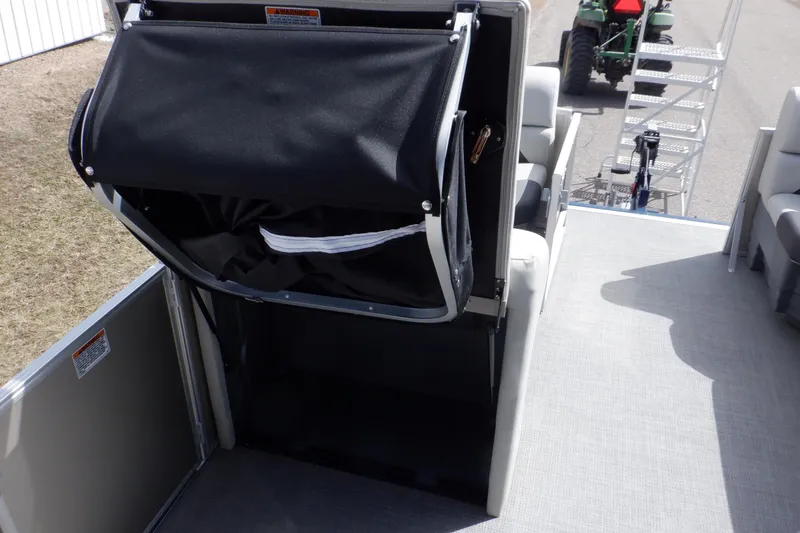 Slide: The Image of 2024 SunChaser Geneva Cruise 22 LR DH pontoon boat interior with plush seating and spacious layout. - 28