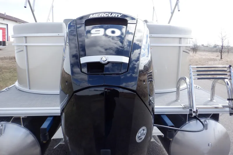 Slide: The Image of 2024 SunChaser Geneva Cruise 22 LR DH boat propeller and pontoons on pavement. - 6