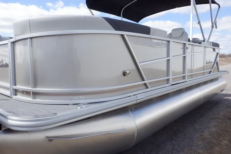 Slide: The Image of 2024 SunChaser Geneva Cruise 22 LR DH pontoon boat with sleek silver design. - 9