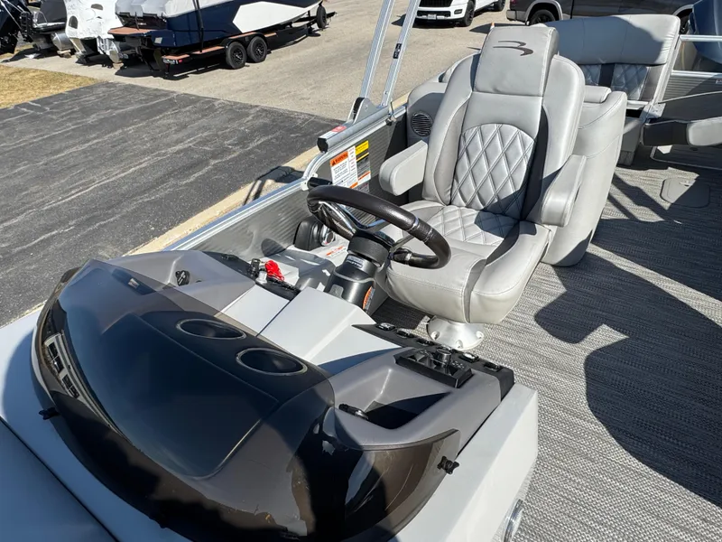 Slide: The Image of 2019 Bennington R 25 RSR boat interior with steering wheel and plush seating. - 16