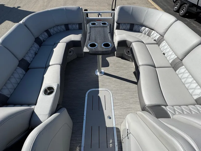 Slide: The Image of Luxurious seating on a 2019 Bennington R 25 RSR pontoon boat with cup holders and table. - 24