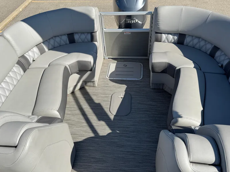 Slide: The Image of 2019 Bennington R 25 RSR pontoon boat with spacious gray seating and carpeted deck. - 25