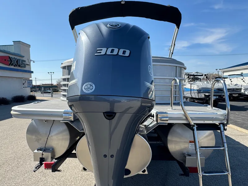 Slide: The Image of 2019 Bennington R 25 RSR pontoon boat with powerful 300 HP engine, docked outdoors. - 32
