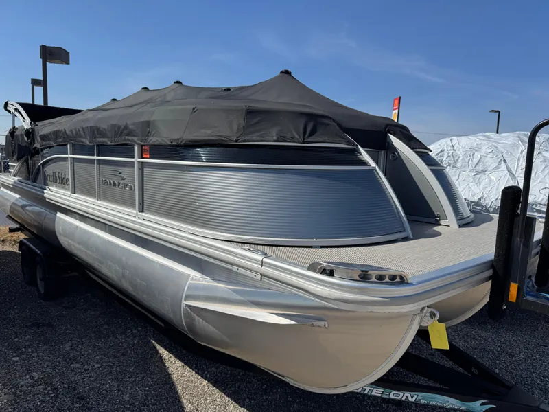 Slide: The Image of 2019 Bennington R 25 RSR pontoon boat with black cover on trailer. - 34