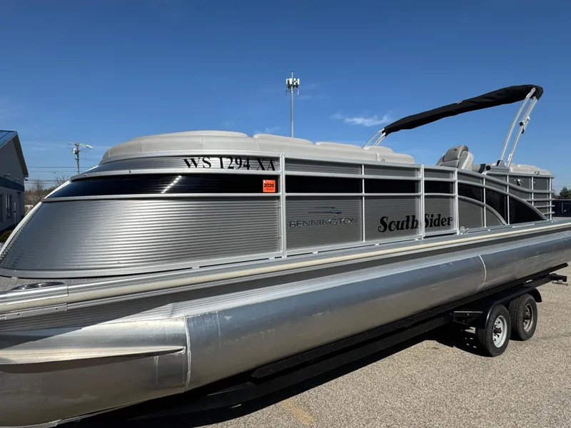 Slide: The Image of 2019 Bennington R 25 RSR pontoon boat on trailer, silver with "South Sider" text. - 5