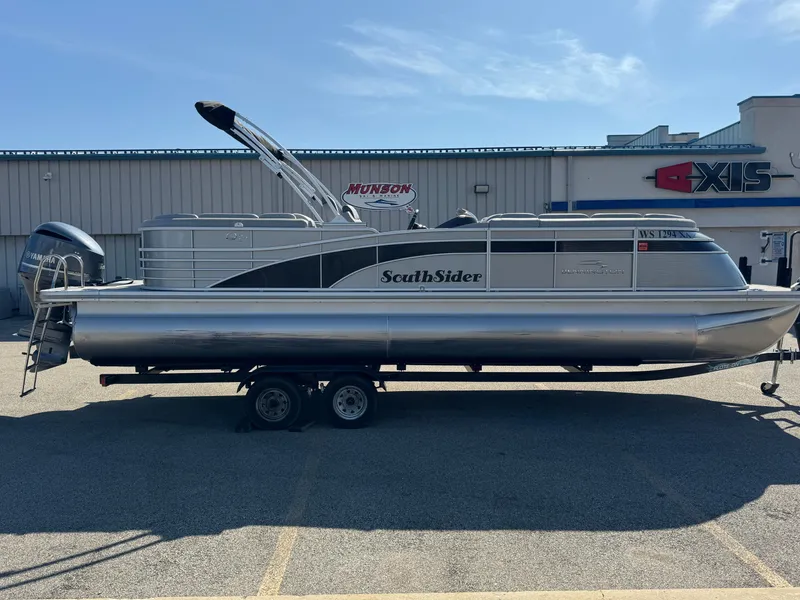 Slide: The Image of 2019 Bennington R 25 RSR pontoon boat on trailer, parked outdoors. - 9