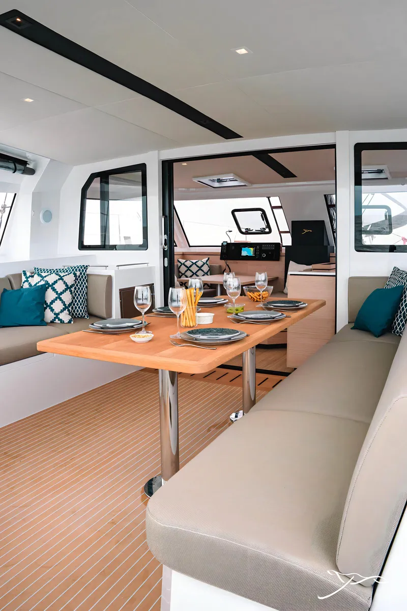Slide: The Image of 2025 Nautitech 40 Open yacht interior with elegant dining setup and modern design. - 25