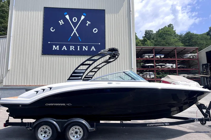 Slide: The Image of 2025 Chaparral 230 SSi boat at Choto Marina, displayed on a trailer. - 15