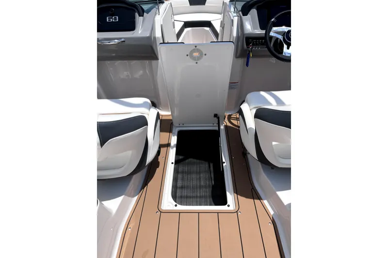 Slide: The Image of 2025 Chaparral 230 SSi boat interior with open storage compartment and seating. - 4