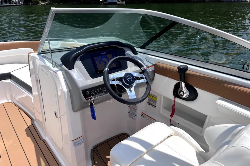 Slide: The Image of 2025 Chaparral 230 SSi boat interior with modern dashboard and steering wheel. - 6