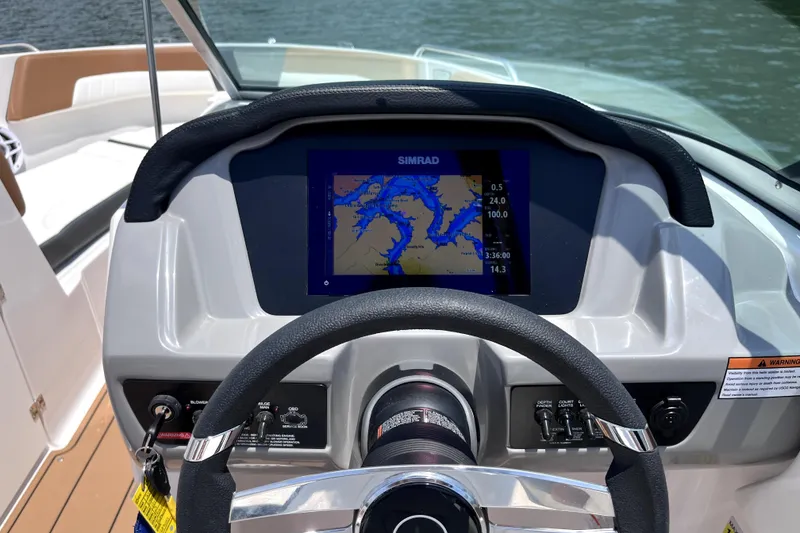 Slide: The Image of Steering wheel and navigation display of 2025 Chaparral 230 SSi boat. - 7