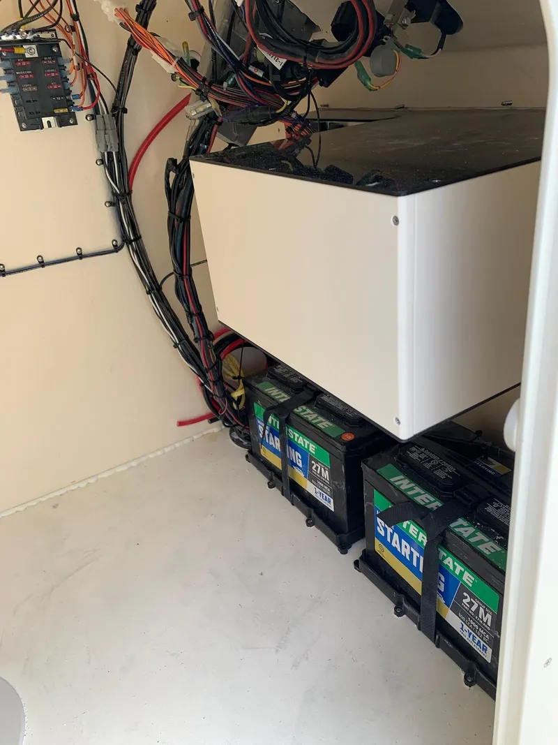 Slide: The Image of Interior view of 2025 Jones Brothers 23 Cape Fisherman boat showing battery compartment and wiring. - 12