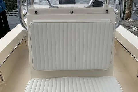 Slide: The Image of 2025 Jones Brothers 23 Cape Fisherman boat interior with white cushioned seating. - 14