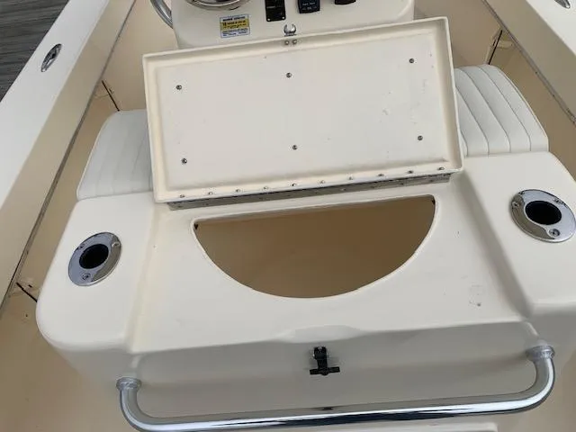 Slide: The Image of 2025 Jones Brothers 23 Cape Fisherman boat with open storage compartment and cup holders. - 8