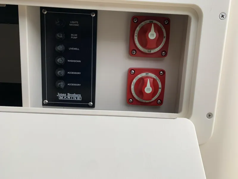 Slide: The Image of Control panel of 2025 Jones Brothers 23 Cape Fisherman boat with switches and dials. - 10