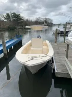 Slide: The Image of 2025 Jones Brothers 23 Cape Fisherman boat docked on a calm, cloudy day. - 3