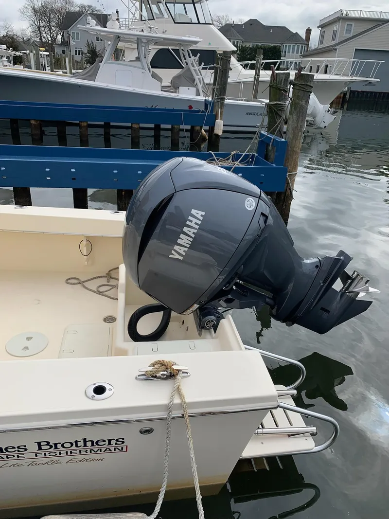 Slide: The Image of Jones Brothers 23 Cape Fisherman 2025 with Yamaha outboard motor docked at marina. - 6