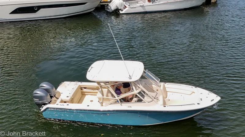 Slide: The Image of 2019 Grady-White Freedom 275 boat on water, featuring dual engines and sleek design. - 12