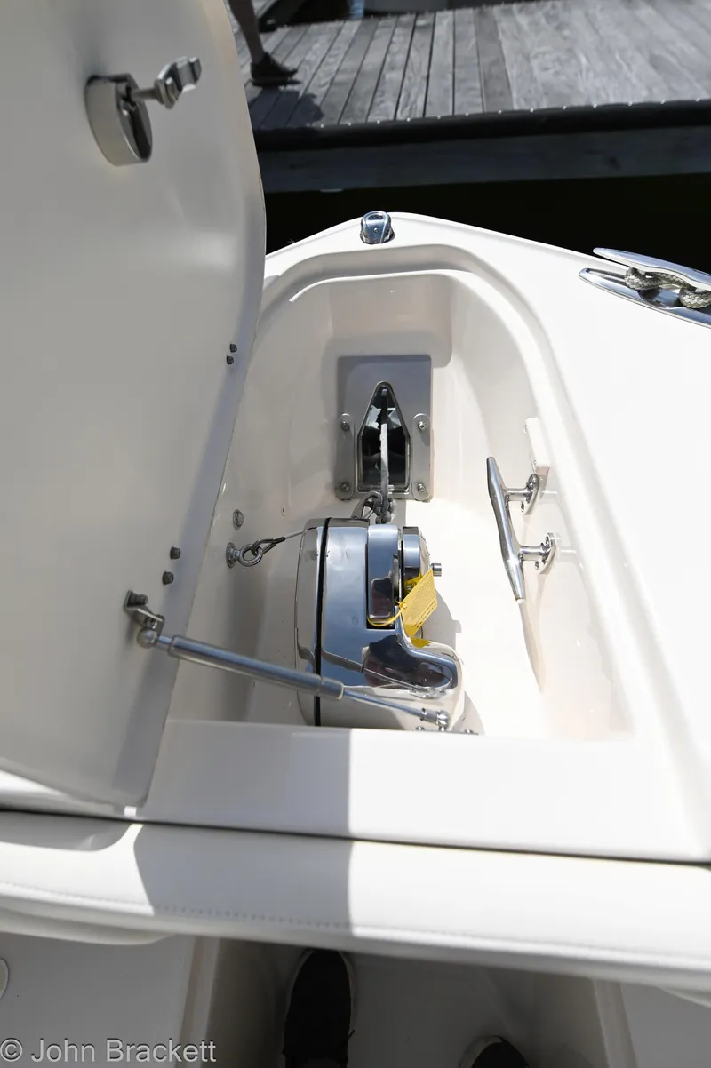 Slide: The Image of 2019 Grady-White Freedom 275 anchor locker with open hatch. - 17