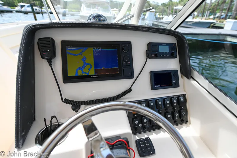 Slide: The Image of 2019 Grady-White Freedom 275 boat dashboard with navigation and control systems. - 21