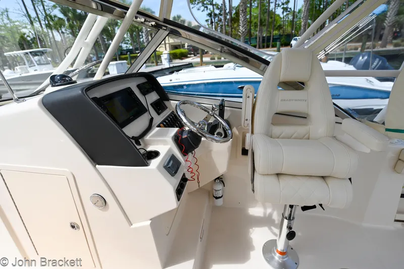 Slide: The Image of 2019 Grady-White Freedom 275 boat interior with steering wheel and captain's chair. - 22