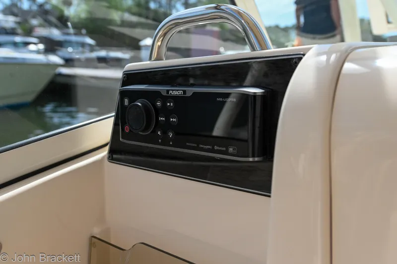 Slide: The Image of 2019 Grady-White Freedom 275 boat stereo system, featuring Fusion audio controls. - 24