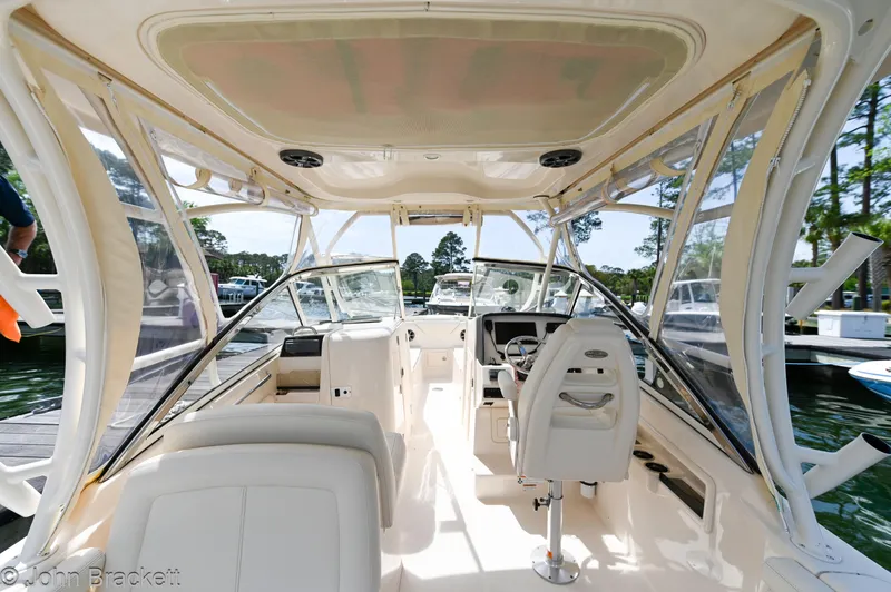 Slide: The Image of 2019 Grady-White Freedom 275 boat interior with helm and seating, docked at marina. - 25