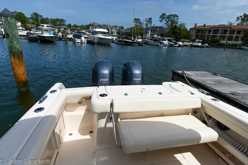 Slide: The Image of 2019 Grady-White Freedom 275 boat docked in a marina with twin engines. - 26
